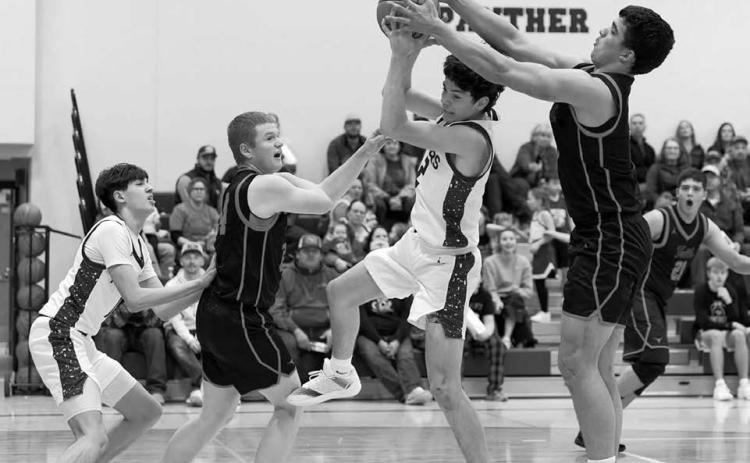 Panther guard Pete Maher splits a pair of Faith defenders on his way to the hoop during Timber Lake’s 59-- 42 win over the Longhorns last Thursday, Jan. 8. Looking on is Jackson Bigger (left). The Panthers are 5-2 overall heading into this week’s schedule. Topic Photo/Marie DuPreez