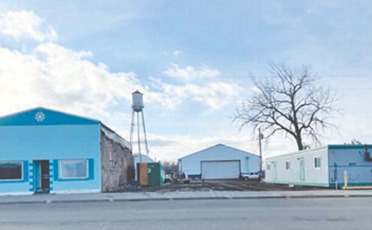 Demolition of the Schlosser building opened a spot where owner Stan Schlosser plans to move the small building shown at right to replace it. The blue building at left was formerly the Senior Center, then storage for Biegler Equipment, and later Lilian Turcotte’s vintage shop.