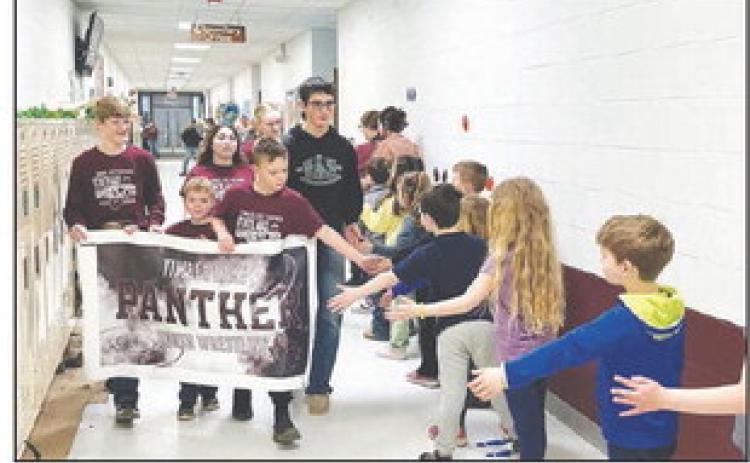 State AAU wrestling qualifiers paraded through the Timber Lake School corridors on Thursday, March 14 to be cheered on by students and staff. Photo by Kathy Nelson