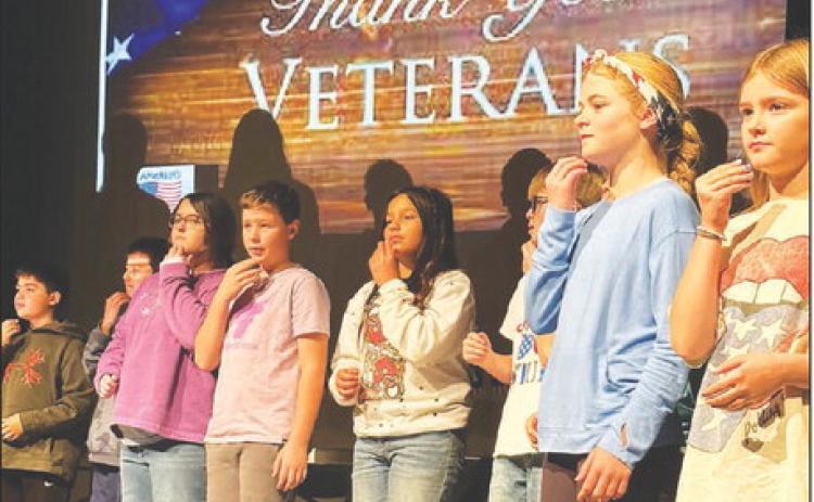 Fifth graders performed “God Bless America” in sign language at the Timber Lake Elementary School Veterans Day program on November 10. L-R are Glen Mowrer, John Bigger, Lilly Goodine, Kyren Ley, Marley Ward, Luke Beer, Alexa Roggow, and Lily Handeland. Each third, fourth and fifth grade class performed. Photo by Kathy Nelson