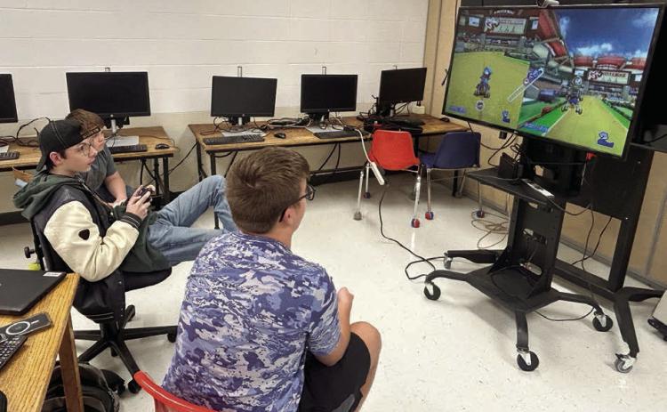 Johnny Hoyt (center) and Evan Schweitzer (right) compete in eSports league games while Nathaniel O’Bryan (far left) looks on. The Timber Lake High School eSports team is wrapping up its first season with playoffs beginning next week.