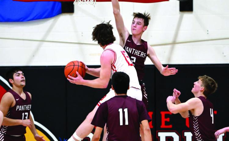 Timber Lake’s Kyler Bollinger (2) uses his 6-2 frame and long reach to defend the basket during recent action against Bison. Looking on and positioning for the blocked shot or rebound are the senior guard’s teammates Aidan Rough Surface (13), Tristan Dupris (11) and Gracen Hansen (4). Bollinger scored 13 points and grabbed a half-dozen rebounds in a 74-34 win over the Cardinals. Photo by Marie DuPreez
