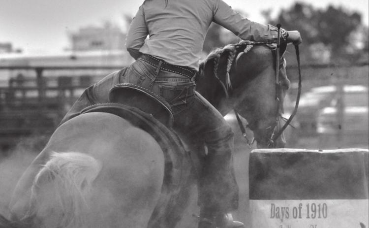 Sydney Maher, Timber Lake, rounds a barrel with the sun setting over Timber Lake during the Days of 1910 rodeo. Maher has been cashing in at recent SDRA events.