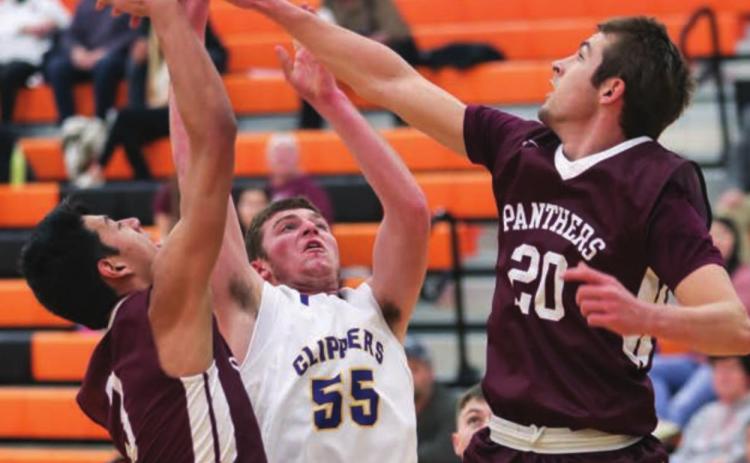 Timber Lake’s Brandt Ducheneaux (20) and Chazz Gabe (3) block the shot of a Strasburg-Zeeland player during their game at Mobridge.