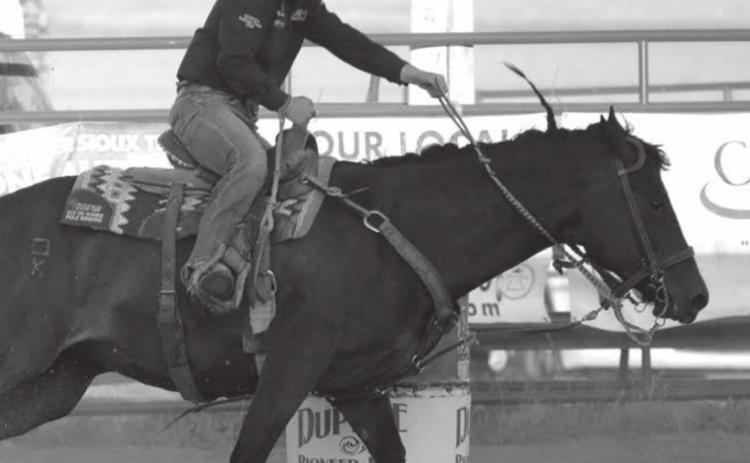 Kesse Deal competes in the barrels at the Dupree Pioneer Days rodeo. Photo by Jon Flatland