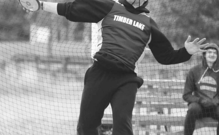 Timber Lake senior AJ Lindskov throws the discus while competing at the Timber Lake Track Invitational at Doug Kraft Field last Tuesday, April 25. Athletes battled cold, gusting winds from the north that put temperatures on the track just above 30 degrees. Lindskov overcame the cold to finish second in the discus with a mark of 105-9 feet.