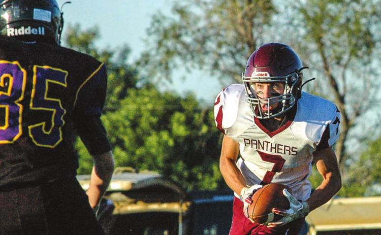 Timber Lake’s Slater Ducheneaux (7) fixes his eyes on Dupree freshman Daxton McDaniel after Ducheneaux made an interception while playing the defensive backfield during their game Friday night in Dupree. Photo by Jon Flatland