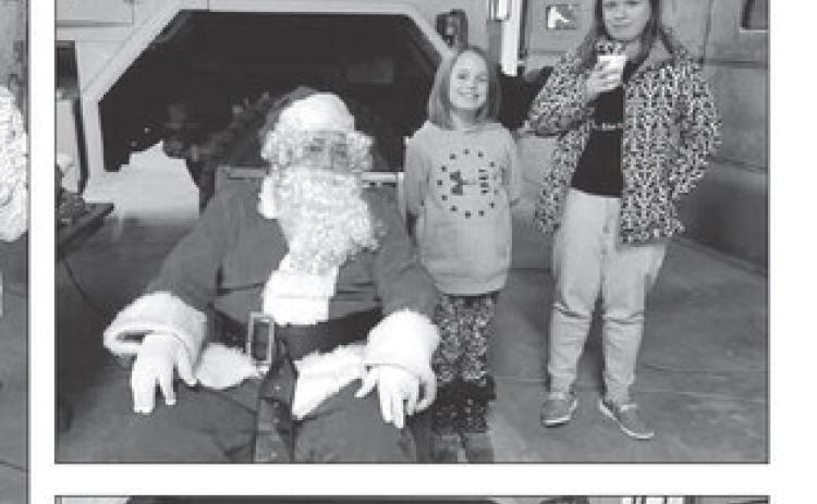 Kids have pictures, hot chocolate with Santa at Isabel