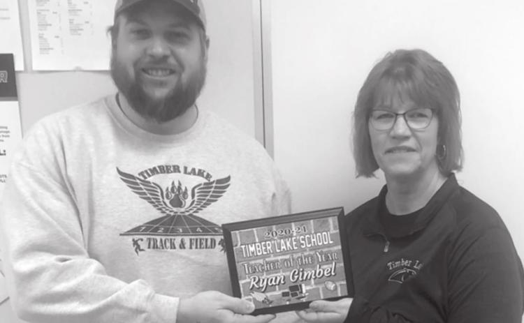 Ryan Gimbel receives the Teacher of the Year Award from Julie Marshall, MS/HS Principal. He will be nominated for the Regional TOY award.