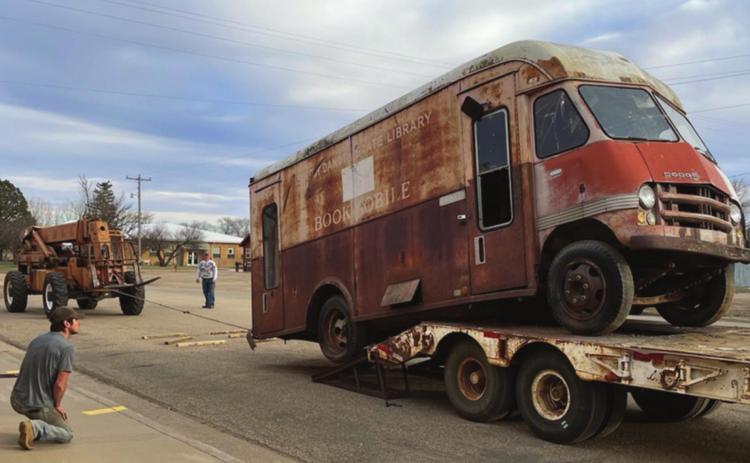 Michael Frank (FRONT) transported the bookmobile from Isabel to Timber Lake, where Marty and Scott Biegler and crew unloaded it. Troy Lindskov recently bought the vacant lot where it was sitting. He and his dad, Corey, helped load it onto Frank’s flatbed trailer. Photos by Kathy Nelson