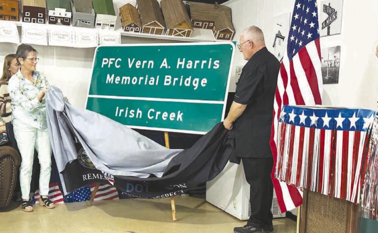 The Fallen Heroes Memorial Bridge sign is unveiled by Mary Harris and Jim Harris at Isabel on Sunday.