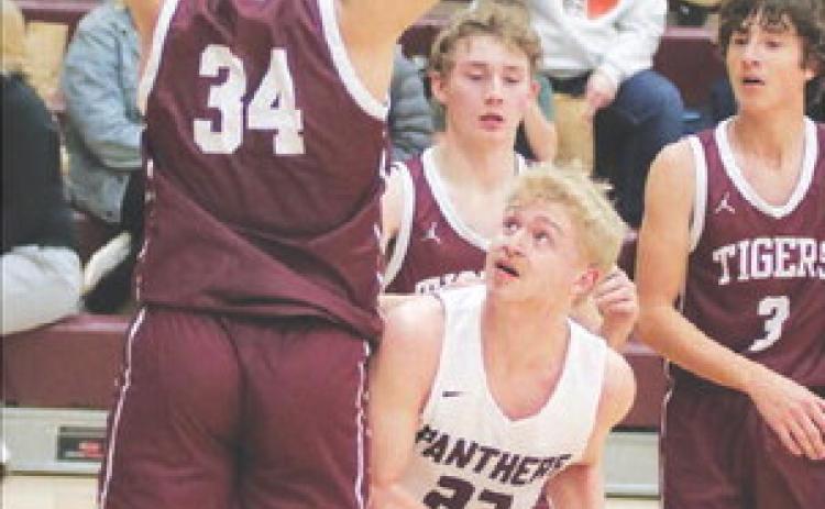 Timber Lake’s lone senior, Brady Sandquist (23) looks for a shot while being defended under the basket during recent action against McIntosh. Photo by Jon Flatland