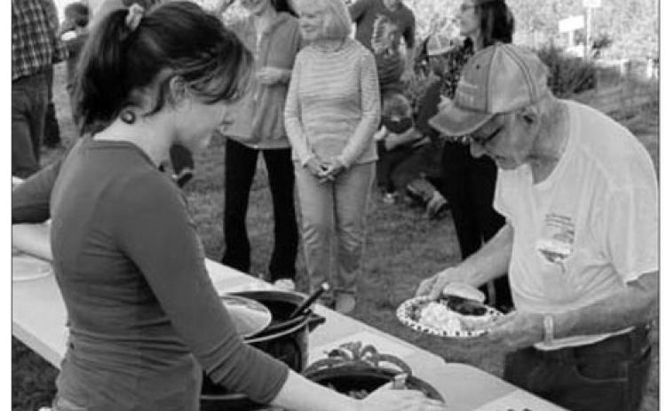 Norman Hieb (RIGHT) was invited to start the line at the meal served at the Timber Lake School Healing Hands (Owaste Napiceya) Garden on September 19. Lola Hornick (LEFT) was one of the servers. Dishes prepared from the garden’s produce were served, along with burgers from beef donated by Lindskov LT Ranch, Schrempp Cattle Co., Maher Ranch, and Hornick Ranch.