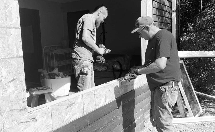 Joel Mattern (RIGHT), owner of J&amp;J Construction of Lemmon and a member of the McIntosh Class of 1972, and one of his employees, Joey Heidecker, install new windows in the McIntosh Daycare.