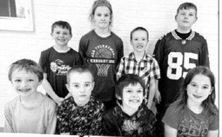 AT RIGHT: 3rd and 4th grade FRONT (L-R): Third graders Ben Mareska and Camden Goldade (winners) and Colton Ridl and Baicyn Lei (alternates). BACK: Fourth graders Barrett Maciejewski and Brynn Lemburg (winners) and Greyson Goldade and Brayden Meier (alternates).