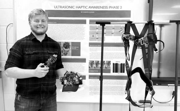 Shawn Quinn shows his winning project, “Ultrasonic Haptic Awareness: Phase 2,” which won him a trip to the Regeneron International Science and Engineering Fair in Los Angeles next month.