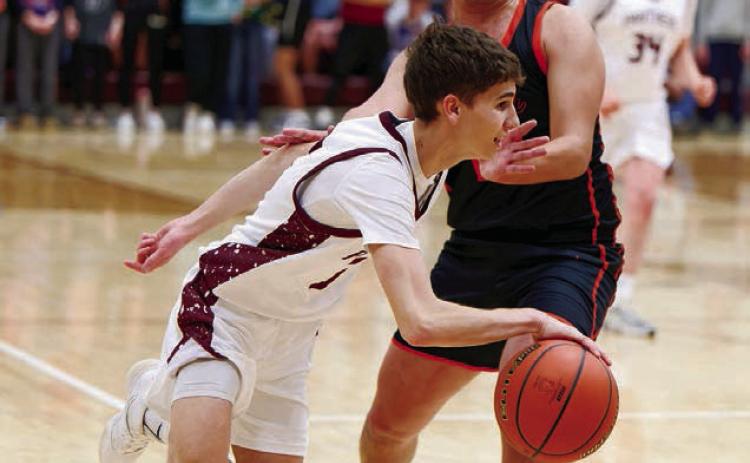 Timber Lake guard Braden Lawrence dribbles past a would-be Faith defender during the Panthers 59-43 conference win over the Longhorns last Thursday, Jan. 8 in Timber Lake. Lawrence finished the contest with eight points and a half-dozen assists. Topic photo by Marie DuPreez