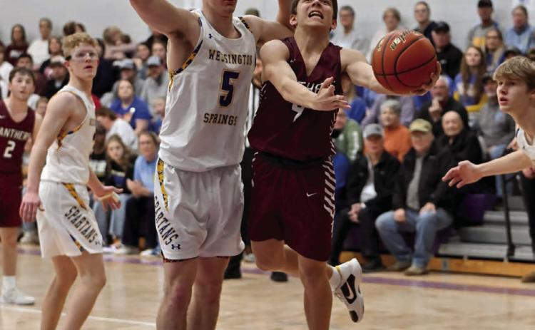 Timber Lake freshman Broc Bauer (right) came off the bench to score five points during the Panthers’ loss to Wessington Springs in the SoDak 16 last week. See Page 10 for game coverage. Photo by Marie DuPreez