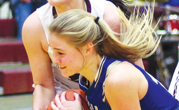 Timber Lake forward Maci Maher (TOP) wrestles an unidentified Wall player for possession of a loose ball during girls hoops action on Friday. Photo by Jon Flatland