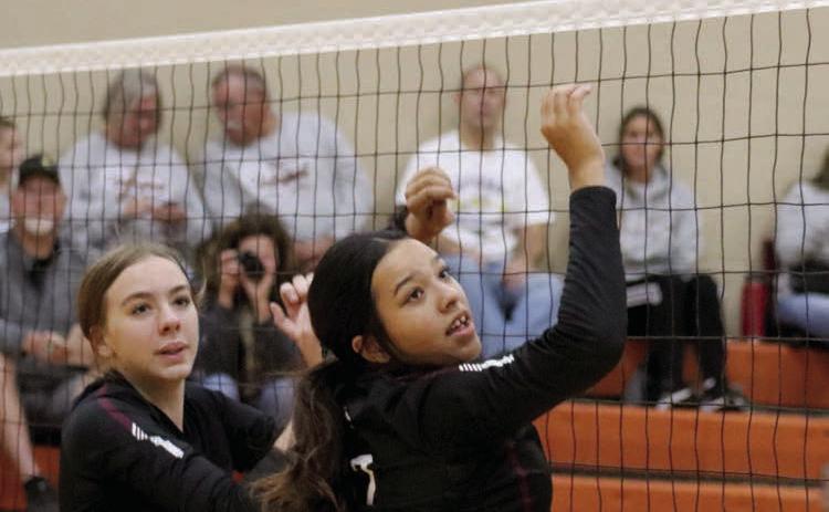 Timber Lake’s Geana Bollinger (left) and Kessa Bigger react to a partially blocked spike during a regular season matchup with Newell. The Panthers downed the Irrigators last week in the Region 8B Tournament. Photo by Jon Flatland