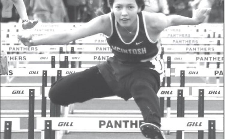 Eighth grader Aleah Hettich of McIntosh eyes the finish line while clearing a barrier in the 100 meter hurdles at the Timber Lake Track Invitational held last Thursday, May 2, at Doug Kraft Field. Hettich won the event and also finished second in the 300 meter hurdles. Photo by Jon Flatland