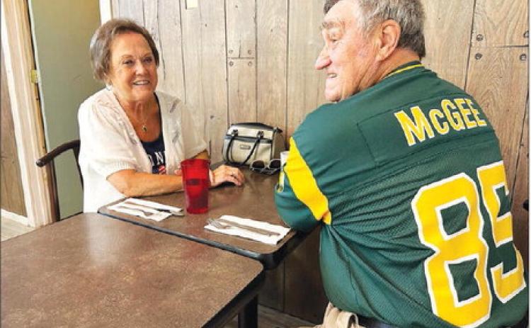 Jim Rolfes, part-owner of the Green Bay Packers, sports his Green Bay #85 Max McGee jersey while having breakfast with his wife, LuElla (Meyer) at Timber Lake during the Days of 1910.