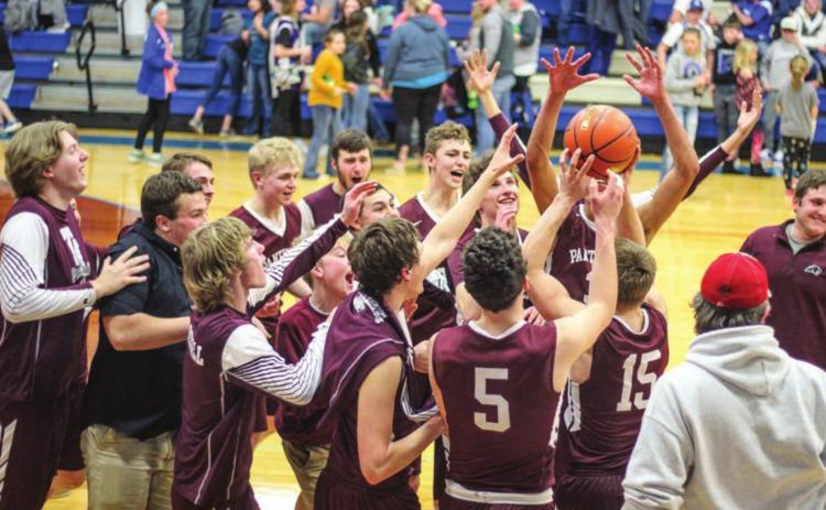 The Timber Lake boys basketball team celebrates its Region 8B finals victory over Lemmon. Photo by Jon Flatland