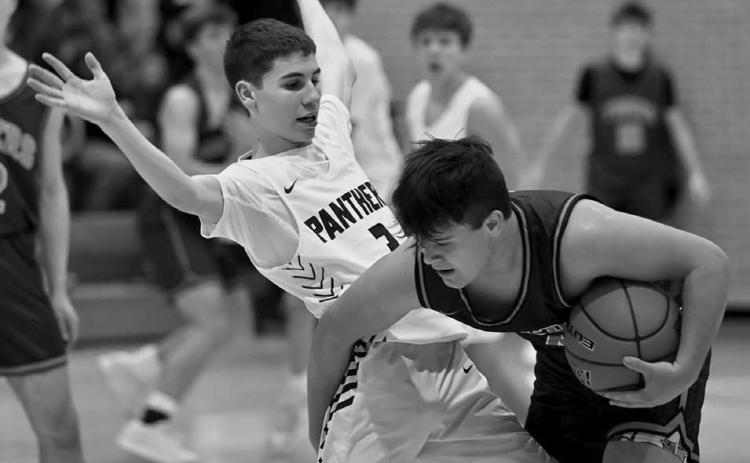 Timber Lake’s Braden Lawrence (left) applies some pressure to a New Underwood ball handler during boys basketball action before the holiday break. Topic photo by Marie DuPreez