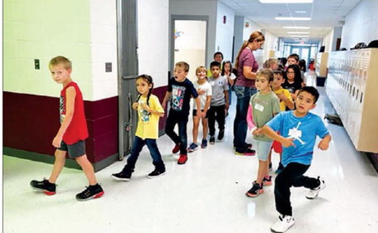 Second graders line up with the help of teacher Shanna Gebhardt on the first day of school at Timber Lake Elementary. Enrollment in the elementary school was at 196 the first week, up 30 from last year.