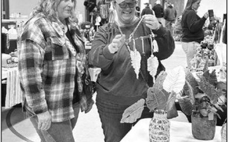 Nancy Olson of McIntosh, left, shows a piece of macrame from her vendor table to Julie Marshall of Timber Lake at the Timber Lake Holiday Craft Fair held Saturday, Nov. 2, at the Timber Lake Community Center.