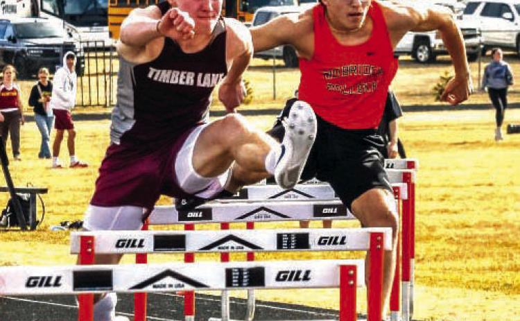 Gracen Hansen of Timber Lake nipped Simon Fried at the finish line to win the 300-meter hurdles at 41.14. With Fried running 41.22, both runners were faster than the meet record 42.49 run by Cody Cotton of Faulkton in 1998. Photo by Jay Davis/Mobridge Tribune