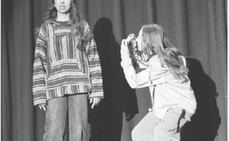 While Izzy (Zoey De La Rosa) shares various interesting facts about birds, Dove (Laynee Bakeberg) captures her emotions and expressions on camera. The two girls received superior acting awards at the regional one-act play competition.
