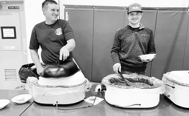 AT RIGHT: Brent Spafford and Riley Lindskov served up chili and chicken noodle soup at the Isabel Firemen’s Supper.