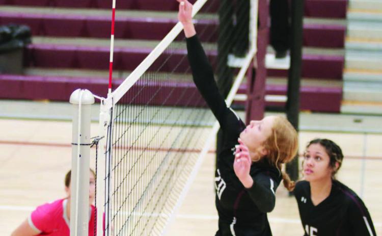 Kendyl Locken, a 5-10 junior, tips a shot over the net during Timber Lake Lady Panther volleyball action against Potter County on Monday, Oct. 17.