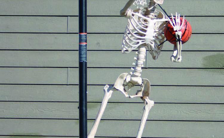 With Halloween and hoops season just around the corner, a skeleton hangs around the Brent and Kaleigh Biegler residence in Timber Lake looking for a game of “horse.” Photo by Jon Flatland