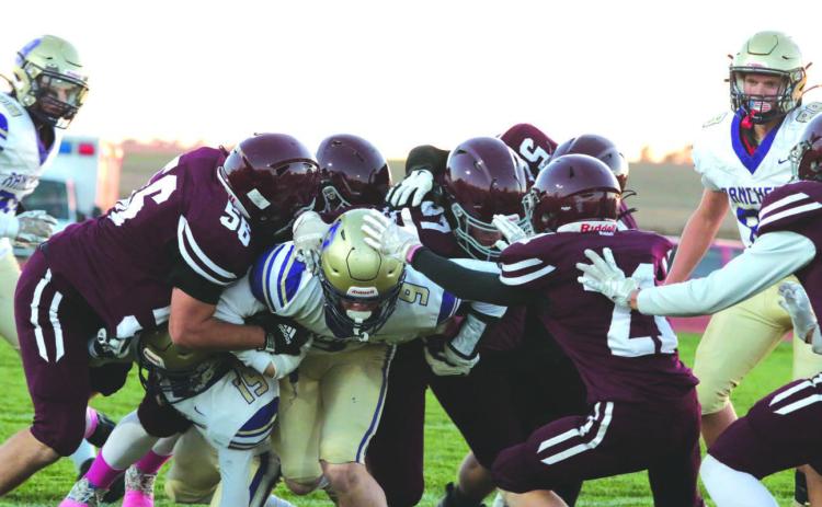 Harding County/Bison running back Rylee Veal, center, proved to be a handful for the Timber Lake Panther defense last Friday. Veal rushed 36 times for 268 yards and scored five touchdowns to lead the No. 5 ranked Ranchers past the Panthers 48-28 to close out the regular season. Combining to bring down Veal on this play were, l-r, Dan Peterson, Mason Arpan, Jack Hornick, Mason Bickel and Eddie Keller. Photo by Jon Flatland