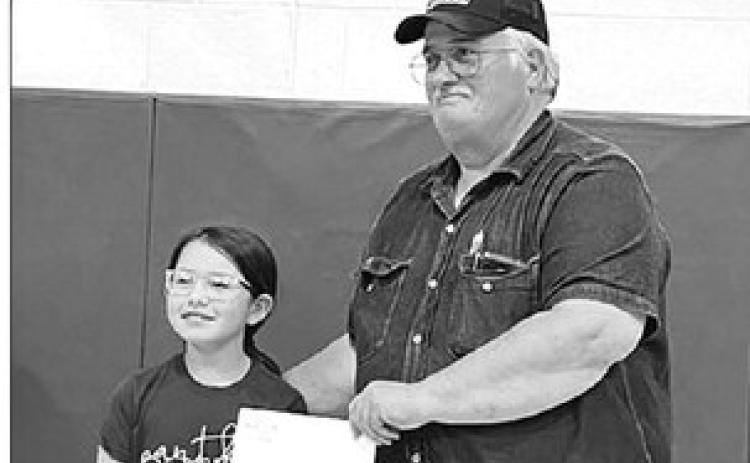 Lance Willison (RIGHT) won the drawing for the $250 grand prize. Timber Lake fourth grader Leah Eigelaar drew names for the prizes.