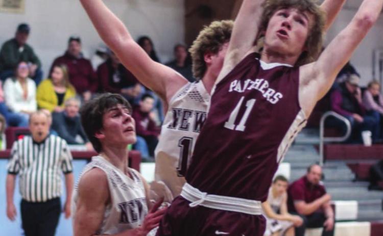 ABOVE: Chase Marshall (11) reaches for a rebound against Newell.