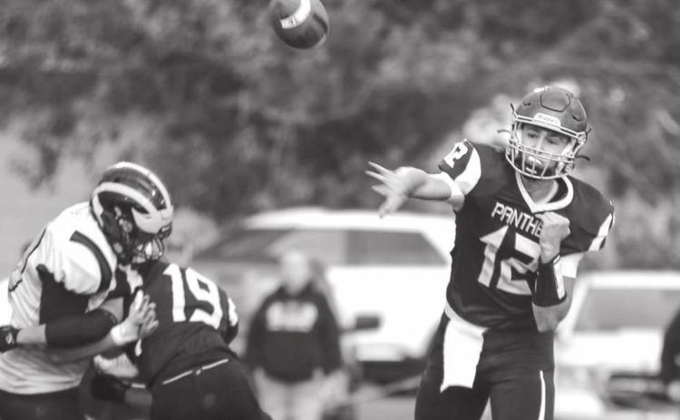 Senior quarterback Kedrick Martin (12) tosses a dart to an open teammate as running back Jayce Lawrence (19) picks up the blitz during the TLHS Panthers’ loss to the HSA Wolverines. Photo by Jon Flatland