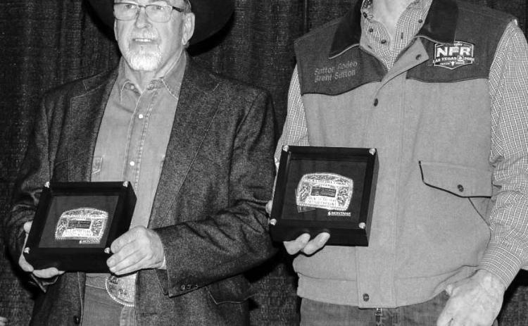 Dallas Schott (left) of McLaughlin and Brent Sutton of Sutton Rodeos, accept the buckles for the Bull of the Year and Bull of the Finals following this year’s PRCA Badlands Circuit Finals last month. Schott in the Dark - a son of the famed bull Bushwhacker - was crowned Bull of the Year.