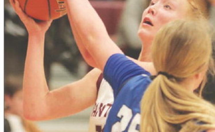 Junior forward Kendyl Locken is fouled by Lemmon’s Madison Dauwen (25) on a drive to the basket during semifinal round action of the 2023 LMC Girls’ Basketball Tournament Friday in Timber Lake. The Cowgirls sank 14 three-pointers to upset the top-seeded No. 3 ranked Lady Panthers 79-54. Photo by Jon Flatland