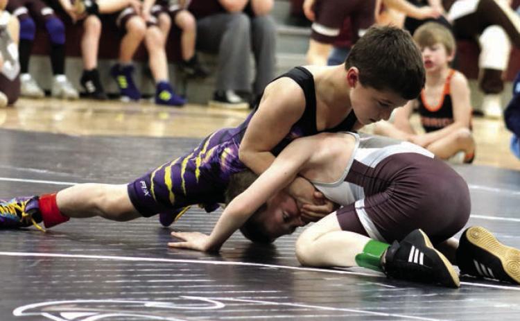 Rowdy Schrempp of Dupree (top) presses a hold on Lincoln Aberle of Timber Lake during recent youth wrestling triangular action. Schrempp will compete in the SDWCA State Wrestling Tournament this weekend in Rapid City. Photo by Jon Flatland