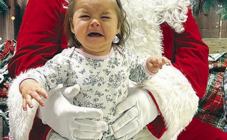 Not everybody was happy to visit with Santa Claus during Timber Lake’s Hometown Christmas event last Friday. Neva Vogel voices her displeasure in meeting the jolly old fellow.