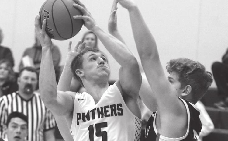 Timber Lake senior Hank Kraft powers to the hoop during home varsity basketball play versus North Central Photo by Jon Flatland