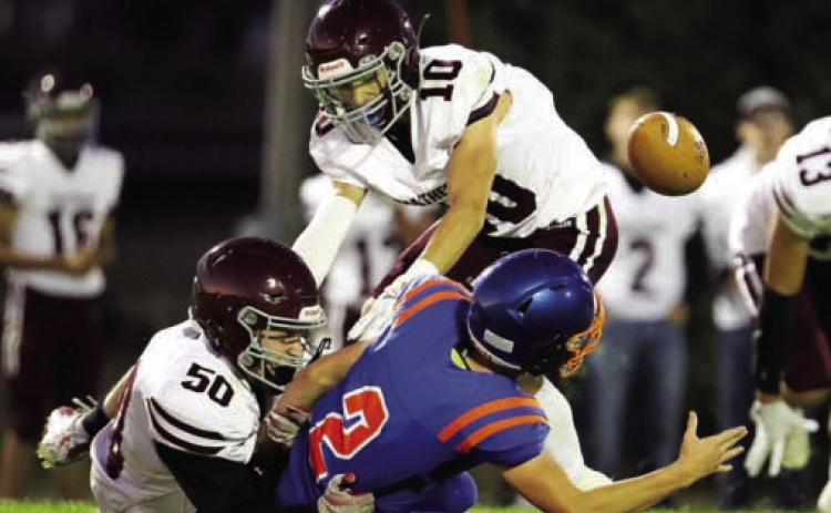 Landon Lemburg (50) and Gavin Farlee (10) force a fumble while bringing down a Stanley County ball carrier in action earlier this season. The Panthers finished the season 4-5 overall after being eliminated from the playoffs last Thursday. Photo courtesy of 605 Sports