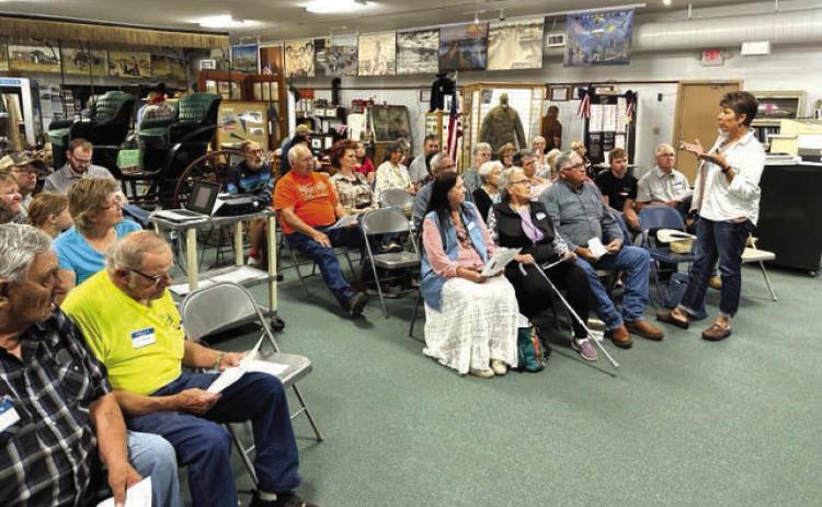 Monica Lawrence of White Horse (FAR RIGHT) speaks to the gathering at the grand opening of the new White Horse Winter Count exhibit. She complimented the committee that created the exhibit, saying it took the museum to a whole new level compared with many others she has visited.