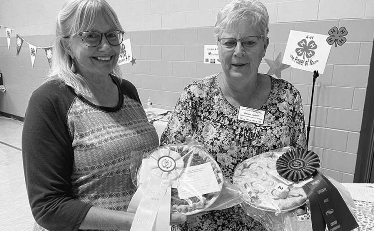 Diana Aberle (left) baked the reserve champion pie at the Dewey County Fair, and Dawn Leibel won the grand champion ribbon and cash award for her pie and reserve champion for her cookies.