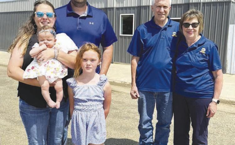 Max and Pam Schott (left), with daughters Grace and Remy, are the owners of Schott Sales, LLC, formerly Biegler Equipment in Timber Lake. The Schotts say they want to continue the same service that Bart and Marlene Biegler (right) have provide to customers for 37 years. You can watch for Schott’s Sales in the Days of 1910 parade on Saturday. Photo by Kathy Nelson