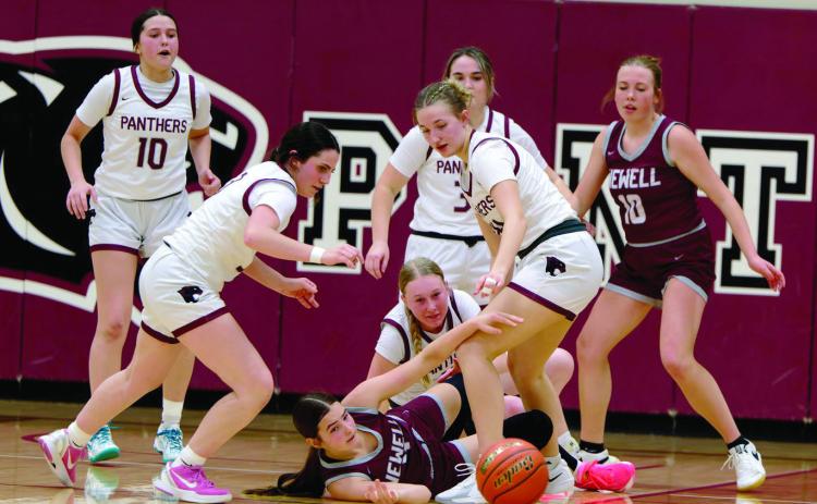 Timber Lake and Newell players scramble for possession of a loose ball during Timber Lake Lady Panther action vs the Newell Irrigators last Friday, Feb. 13. The Lady Panthers pulled out an exciting 41-48 win over the Irrigators. The Timber Lake girls are used to exciting finishes as nearly half of their games this season have been decided one way or the other by seven points or less. Topic Photo/Marie DuPreez