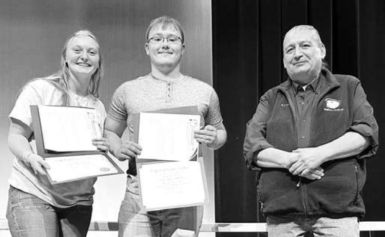 Cheyenne River Sioux Tribe Telephone Authority presented scholarships to Timber Lake High School seniors at Awards Day on May 7. Ken White Eyes, Asst. General Manager, presented the awards. Above: Co-valedictorians Jordan Jones (left) and Gabe Keller received $250 scholarships.